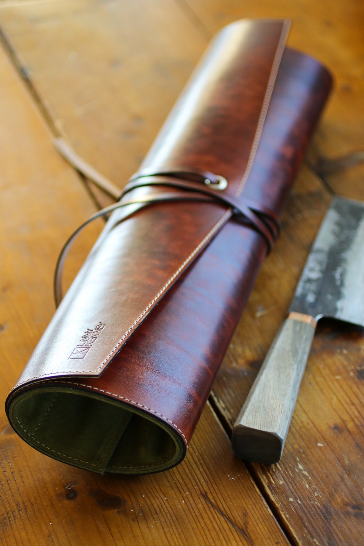 green-and-brown-leather-knife-roll