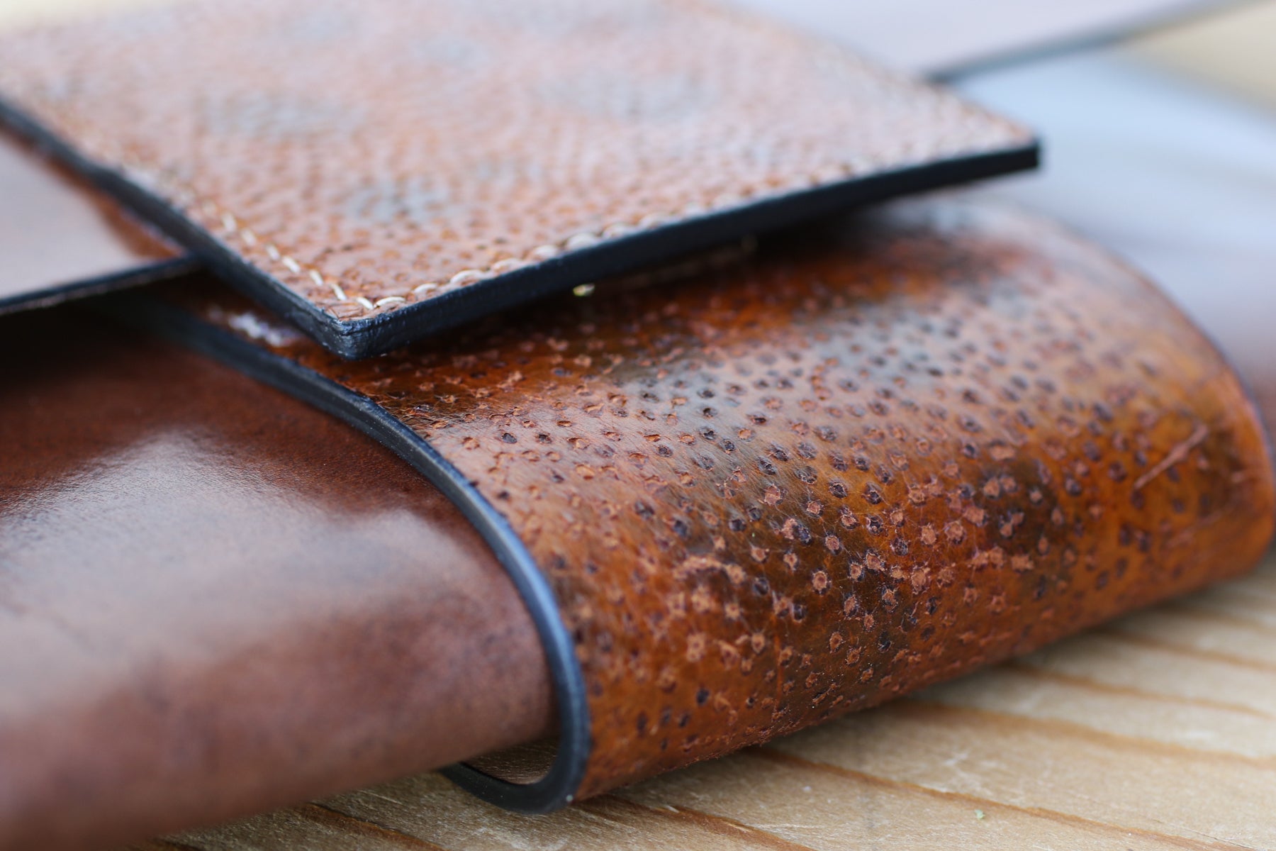 spotted wolffish and leather clutch